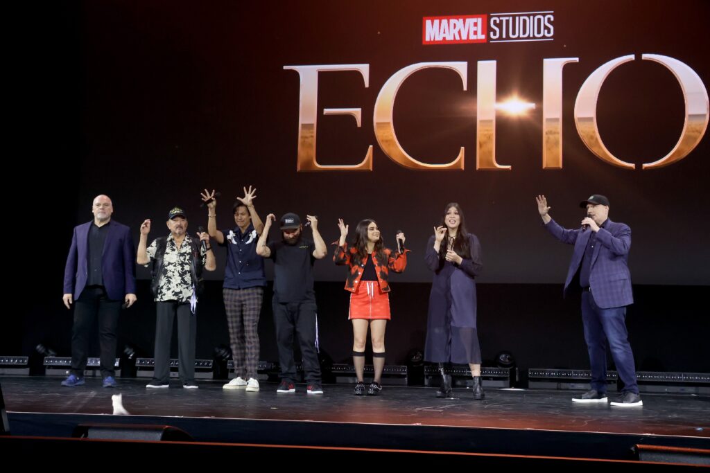 ANAHEIM, CALIFORNIA - SEPTEMBER 10: (L-R) Vincent D'Onofrio, Graham Greene, Chaske Spencer, Cody Lightning, Devery Jacobs, Alaqua Cox, and Kevin Feige, President of Marvel Studios and Chief Creative Officer of Marvel, speak onstage during D23 Expo 2022 at Anaheim Convention Center in Anaheim, California on September 10, 2022. (Photo by Jesse Grant/Getty Images for Disney)