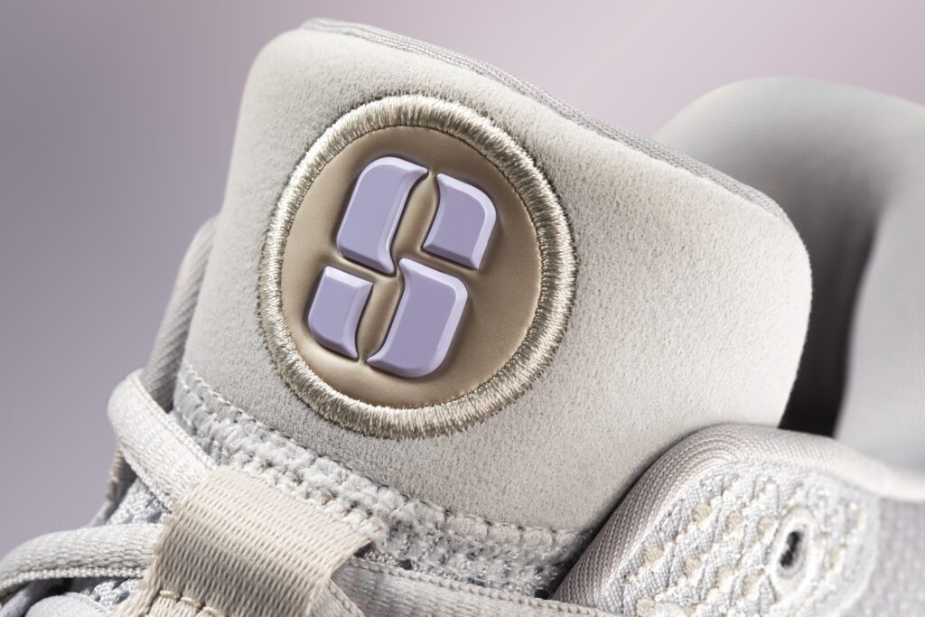 The "S" of Sabrina's logo appears on the heel of her shoe and across her apparel line.